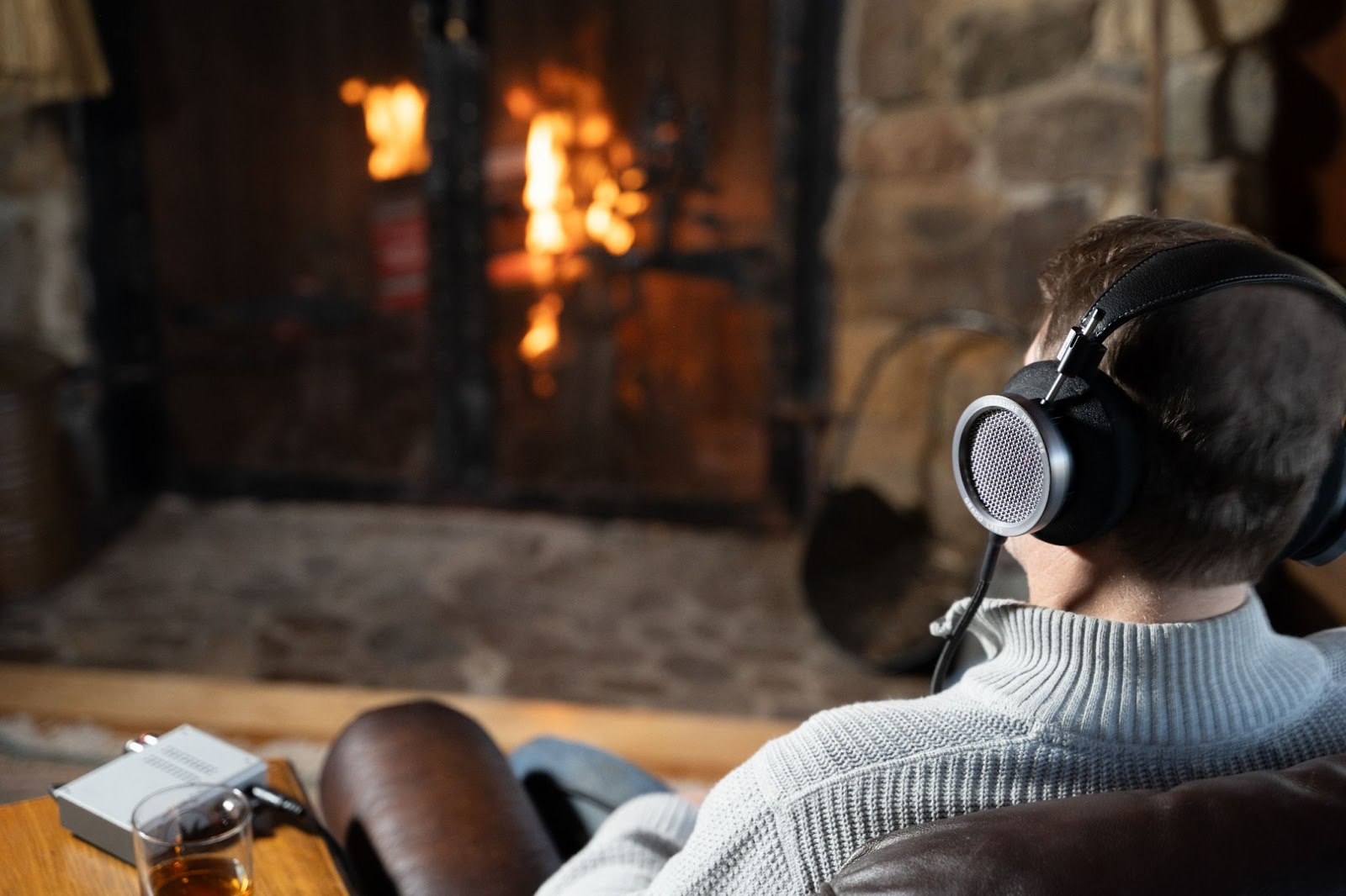 Man wearing Grado Signature HP100 SE headphones in living room.